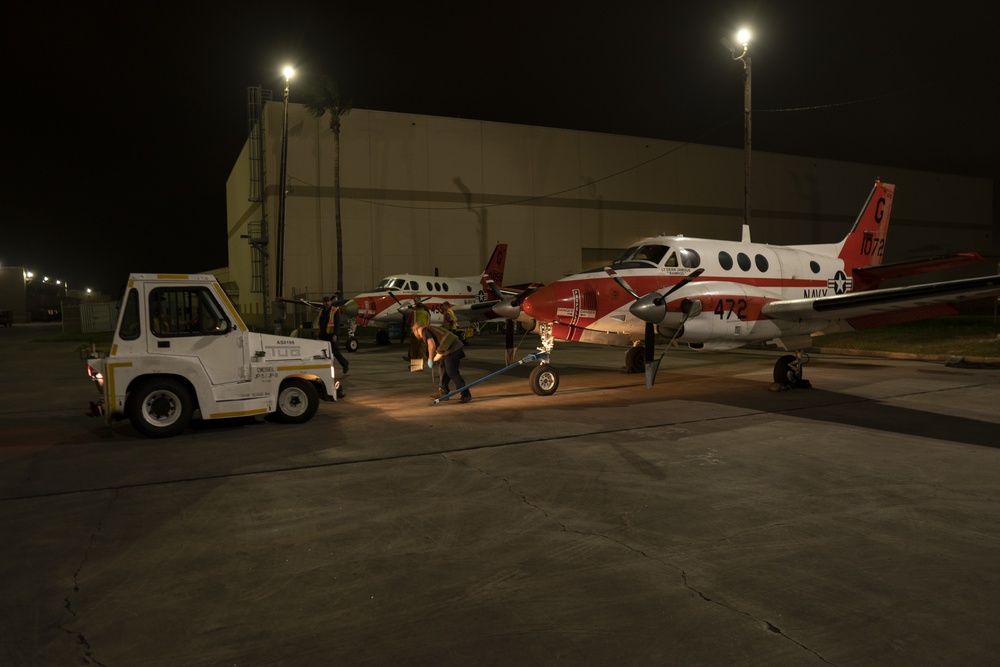 Dyncorp aircraft washers preparing two T-44C Pegasus