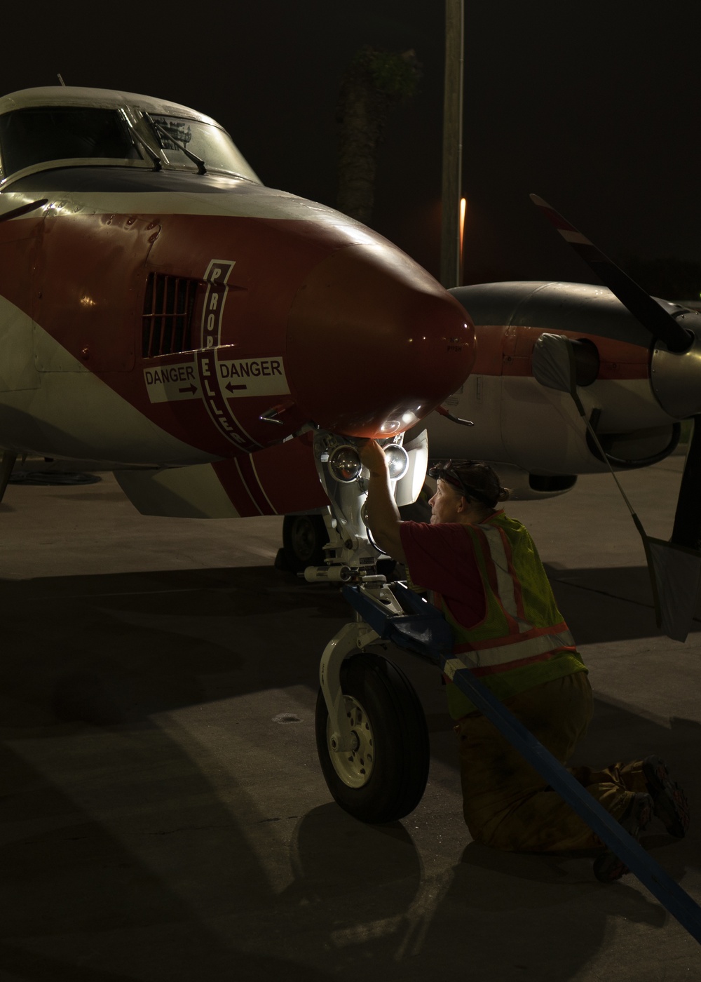 Dyncorp aircraft washer prepares a T-44C Pegasus for a routine cleaning