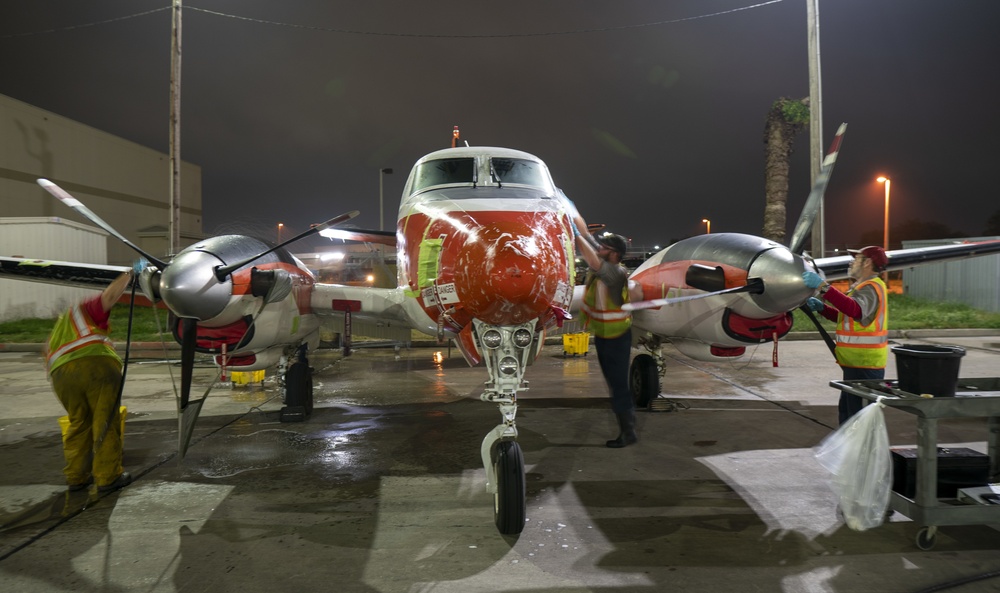 Dyncorp aircraft washer prepares a T-44C Pegasus for a routine cleaning