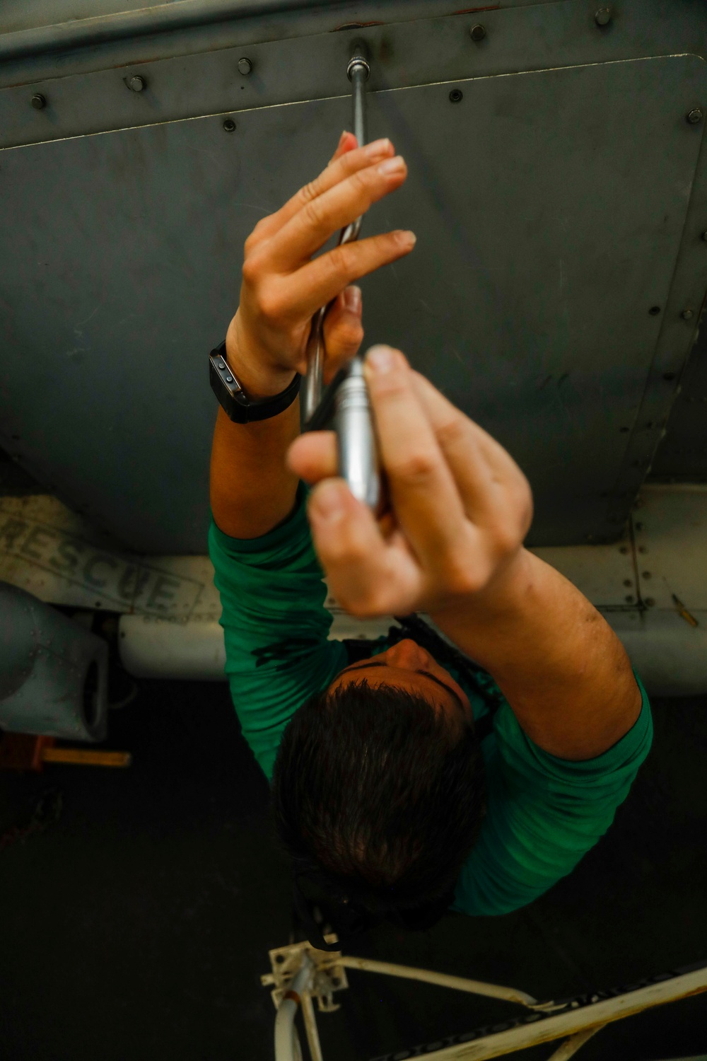 Maintenance in the hangar bay of the Nimitz-class aircraft carrier USS Abraham Lincoln (CVN 72).