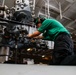 Maintenance in the hangar bay of the Nimitz-class aircraft carrier USS Abraham Lincoln (CVN 72).