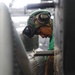 Maintenance in the hangar bay of the Nimitz-class aircraft carrier USS Abraham Lincoln (CVN 72).