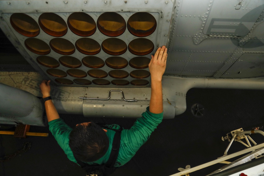 Maintenance in the hangar bay of the Nimitz-class aircraft carrier USS Abraham Lincoln (CVN 72).