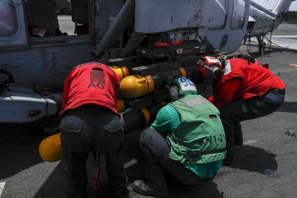 Abraham Lincoln Sailors load ordnance