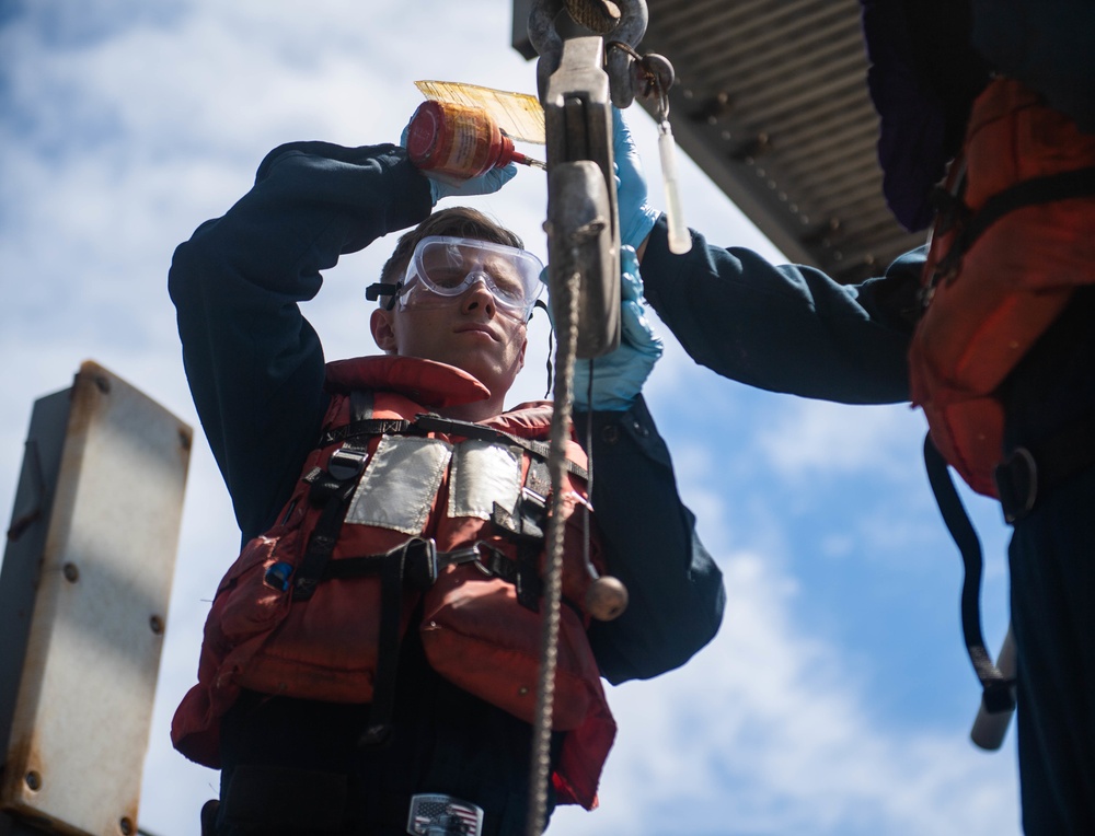 Sailors aboard USS Harpers Ferry Conduct Maintenance