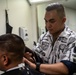 Sailor Cuts Hair aboard USS Harpers Ferry