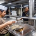 Sailors Serve Dinner Aboard USS Harpers Ferry