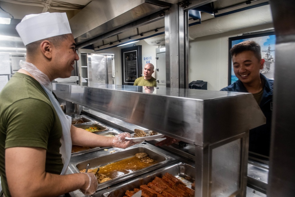 Sailors Serve Dinner Aboard USS Harpers Ferry
