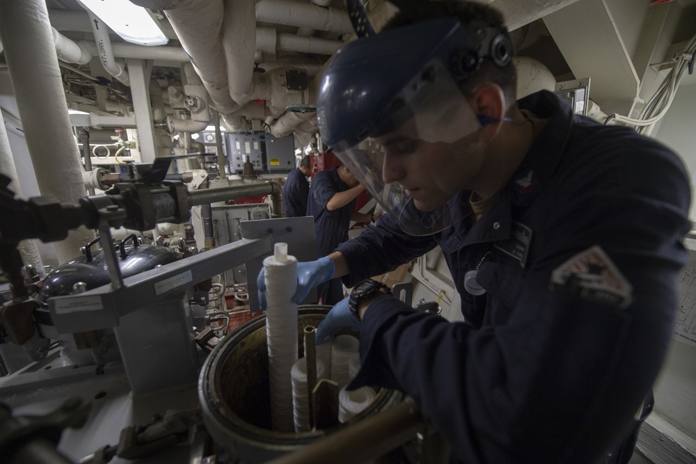 Engineman 2nd Class Joshua Hohn replaces reverse osmosis filters aboard the Arleigh Burke-class guided-missile destroyer USS Momsen (DDG 92).