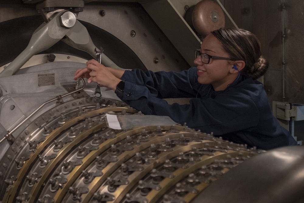 Gas Turbine Systems Technician Mechanical Fireman Azia Martinez performs maintenance on the gas turbine engine aboard the Arleigh Burke-class guided-missile destroyer USS Momsen (DDG 92).