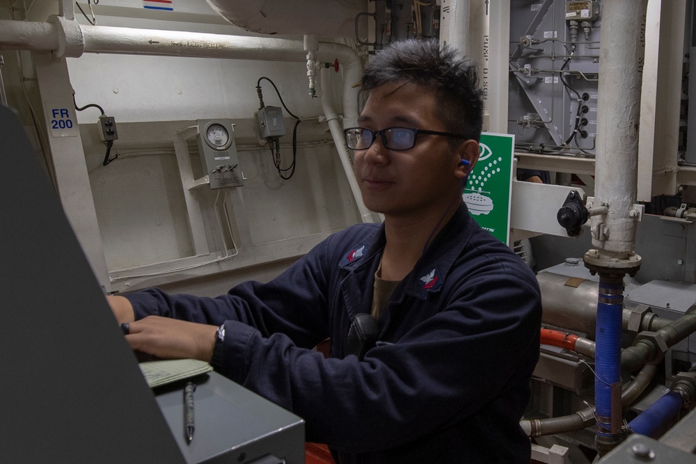 Damage Controlman 2nd Class Micco Sarimento inputs logs on the Integrated Communication Assessment System aboard the Arleigh Burke-class guided-missile destroyer USS Momsen (DDG 92).