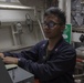 Damage Controlman 2nd Class Micco Sarimento inputs logs on the Integrated Communication Assessment System aboard the Arleigh Burke-class guided-missile destroyer USS Momsen (DDG 92).