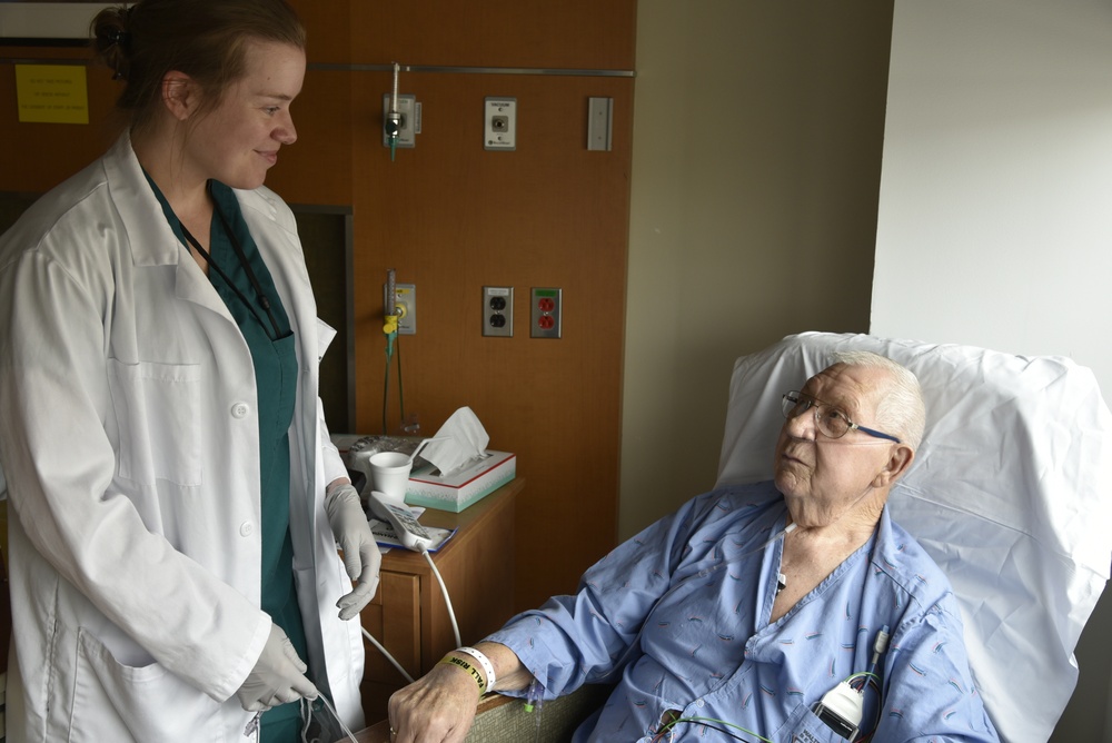 An occupational therapist checks in on a patient in the in-patient wards