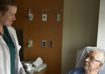 An occupational therapist checks in on a patient in the in-patient wards