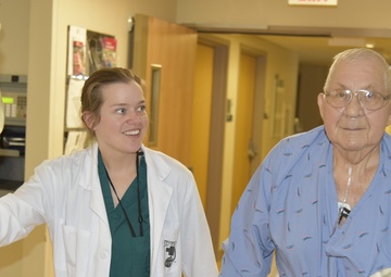 A Walter Reed Bethesda occupational therapist takes a patient for a walk