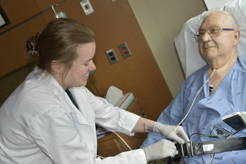 A Walter Reed Bethesda OT prepares a patient to go for a walk