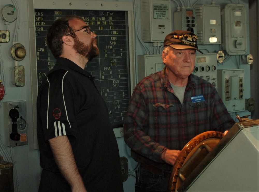 Museum volunteer on simulated bridge of USS Preble (DDG-46)