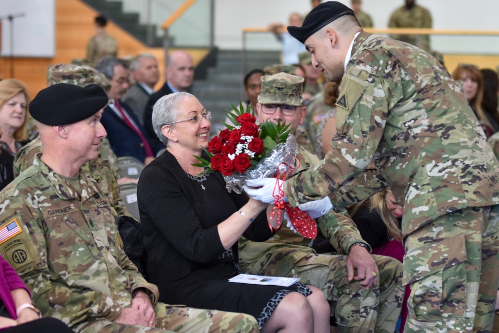 Julie Gardner receives bouquet of roses at husband’s relinquishment of responsibility ceremony