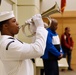 Sailor plays &quot;Taps&quot; on a bugle during a Memorial Day ceremony.