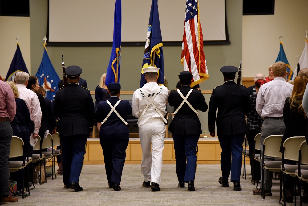 Joint-service flag detail parades the colors during a Memorial Day ceremony.