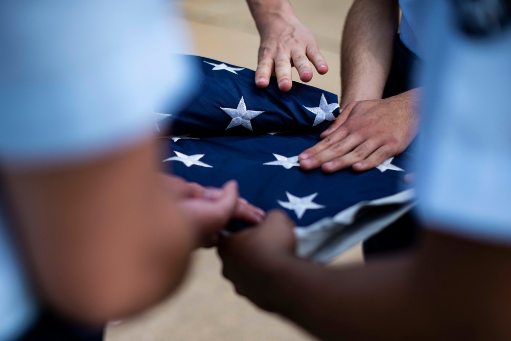Airmen fold the American flag