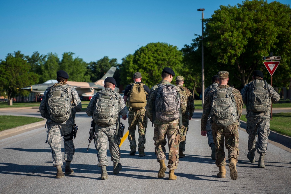 Members of Team Vance participate in a 5K ruck march