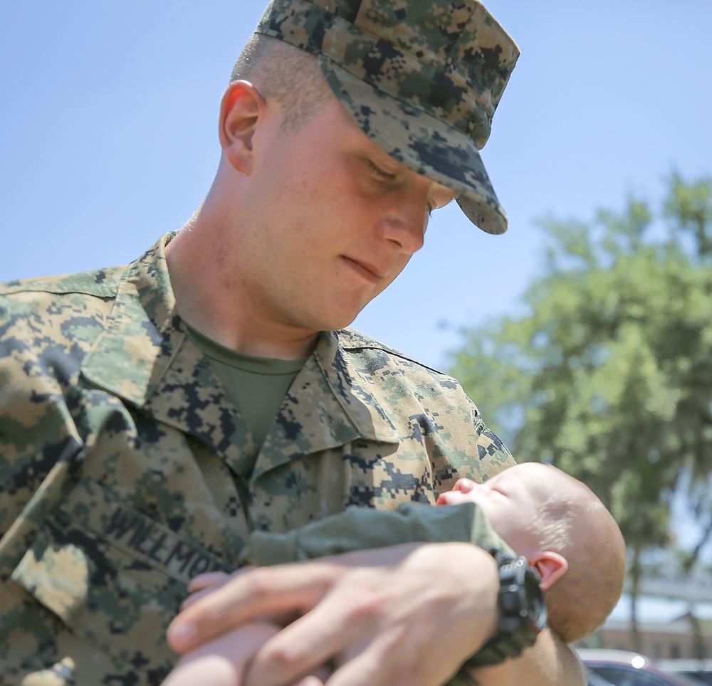 Marine graduate meets newborn son