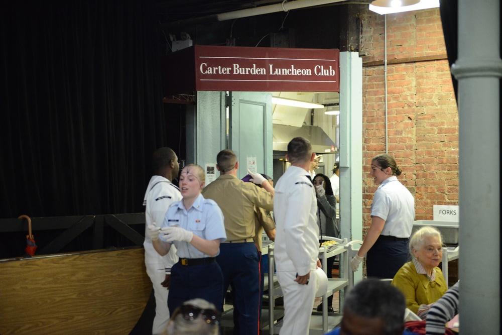 Service members volunteer to serve meals to seniors at Carter Burden Center for the Aging