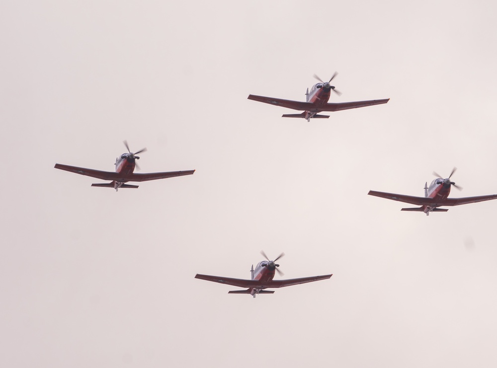 Four T-6B Texan II aircraft from Training Squadron 28 Perform a flyover above Whataburger Field