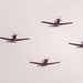 Four T-6B Texan II aircraft from Training Squadron 28 Perform a flyover above Whataburger Field