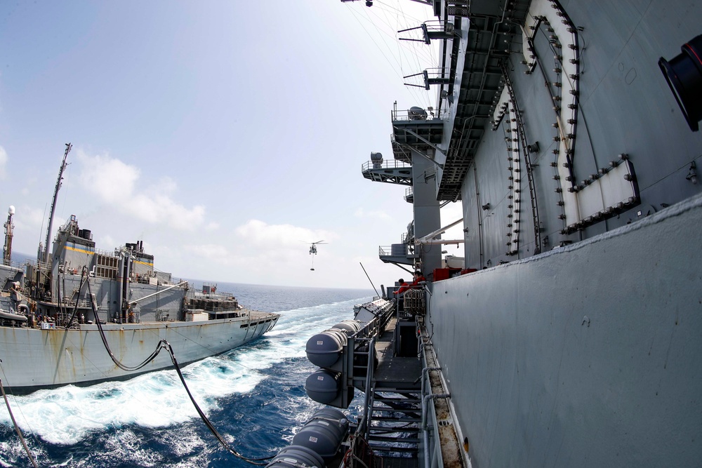 The Nimitz-class aircraft carrier USS Abraham Lincoln (CVN 72) conducts a replenishment-at-sea with the fast combat support ship USNS Arctic (T-AOE 8).