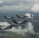 Scat VII, Robin Olds' P-51 Mustang, flies along Spangdahlem F-16C aircraft