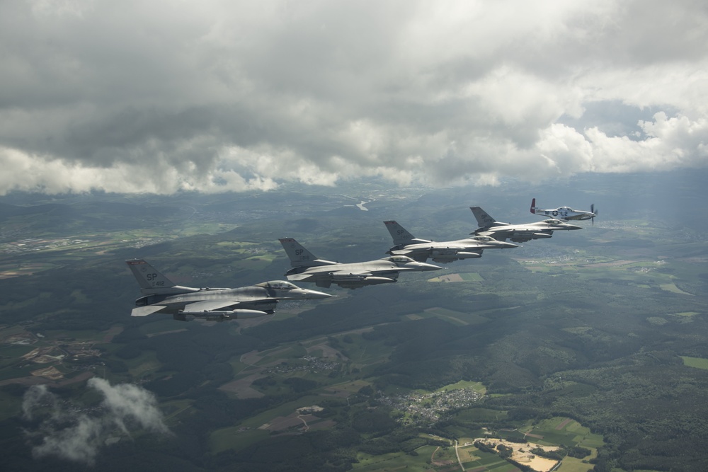 Scat VII, Robin Olds' P-51 Mustang, flies along Spangdahlem F-16C aircraft