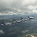 Scat VII, Robin Olds' P-51 Mustang, flies along Spangdahlem F-16C aircraft