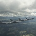 Scat VII, Robin Olds' P-51 Mustang, flies along Spangdahlem F-16C aircraft