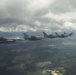 Scat VII, Robin Olds' P-51 Mustang, flies along Spangdahlem F-16C aircraft