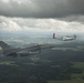 Scat VII, Robin Olds' P-51 Mustang, flies along Spangdahlem F-16C aircraft