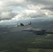 Scat VII, Robin Olds' P-51 Mustang, flies along Spangdahlem F-16C aircraft