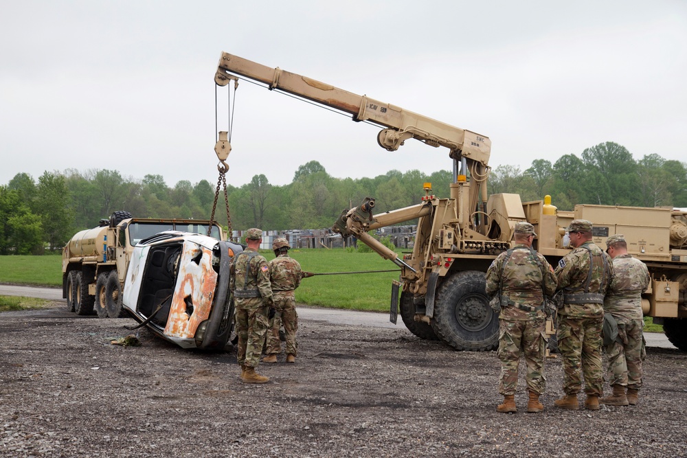 Soldiers Utilize Wrecker to Recover Car
