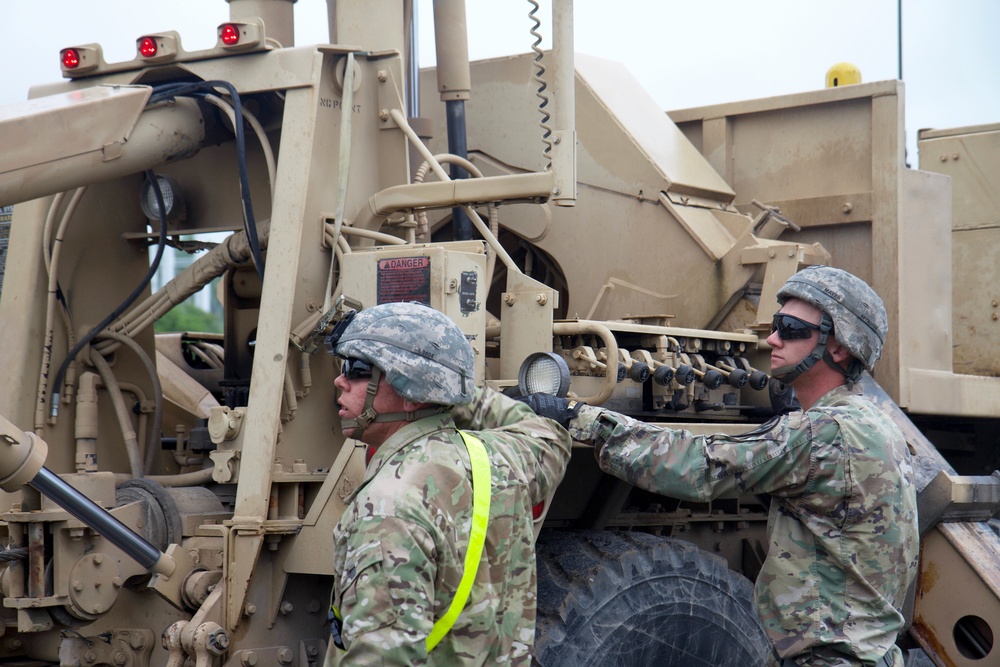 Soldiers Utilize Wrecker to Recover Car