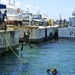 U.S. Navy Diver jumps into the water as part a surface augmented underwater breathing exercise with members of the Barbados coast guard.
