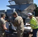 Teamwork fills sandbags along the Arkansas River