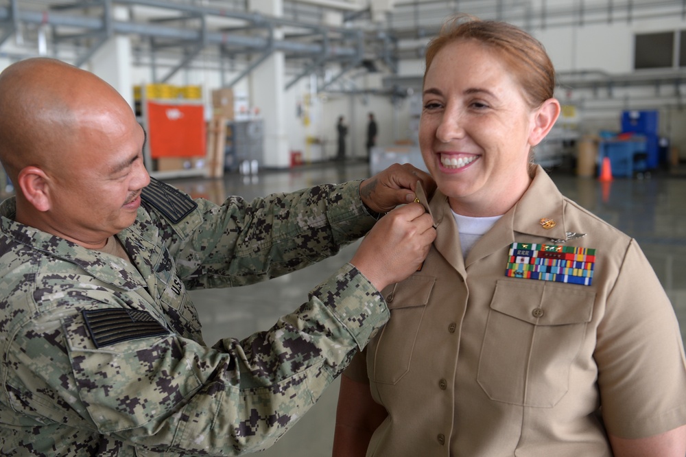 Senior Chief Aviation Machinist Mate Christian Desiderio, assigned to Patrol Squadron (VP) 5, pins newly appointed Senior Chief Aviation Electronics Mate Amanda Carpenter.