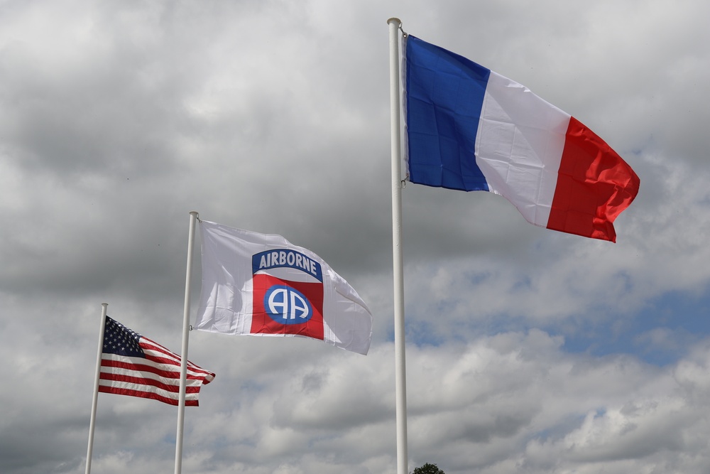 French, U.S. and 82nd Airborne Division flag is flown in Ste. Mere Eglise