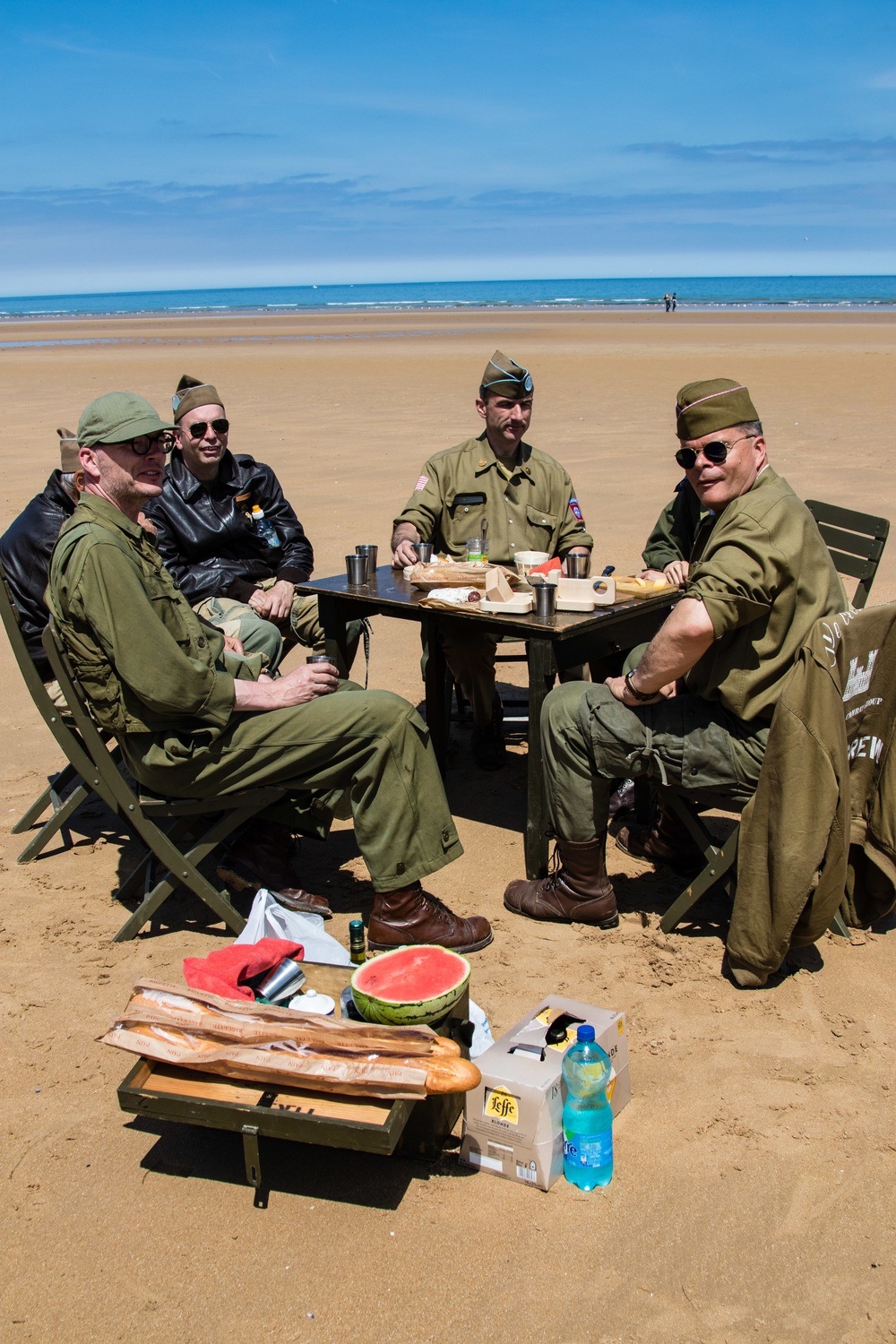 Swedish men have lunch at Omaha Beach, Normandy, France