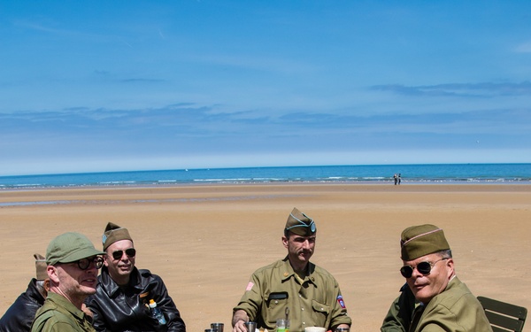 Swedish men have lunch at Omaha Beach, Normandy, France