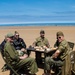 Swedish men have lunch at Omaha Beach, Normandy, France