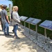 Tourists read memorial plaques