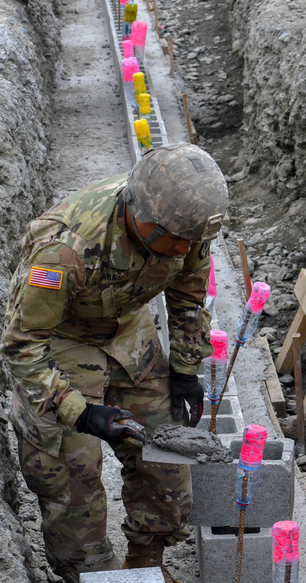 Soldier spreads concrete to build gym in Romania
