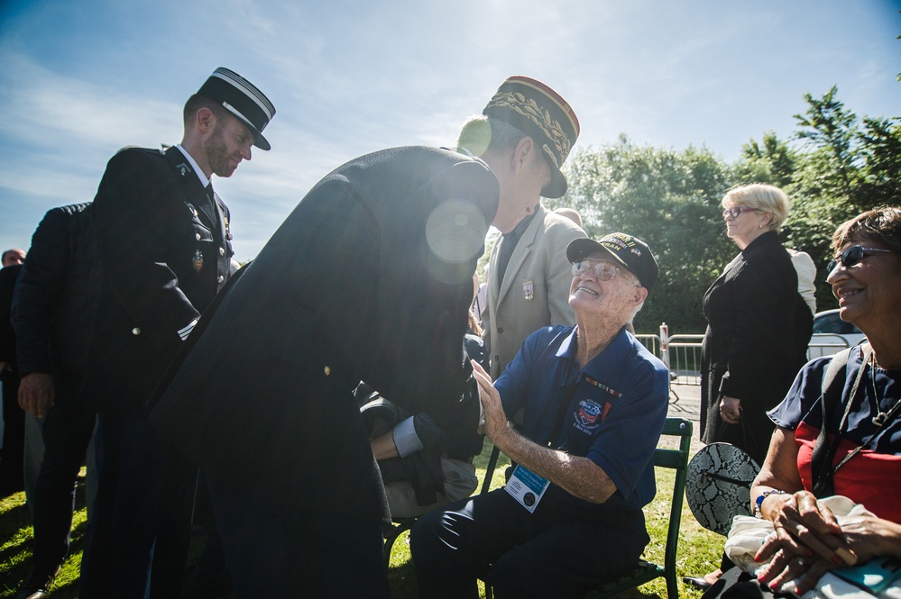 Officials shake hands with World War II veterans